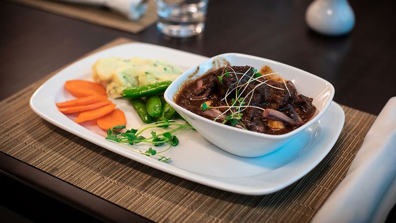 Hearty beef bourguignon with steamed vegetables and mashed potato.