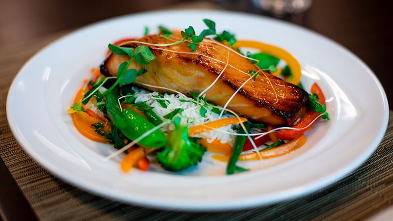 A gorgeous miso-glazed salmon dish paired with well-cooked vegetables.